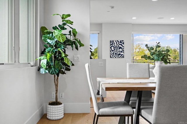 dining area featuring wood finished floors, baseboards, and recessed lighting