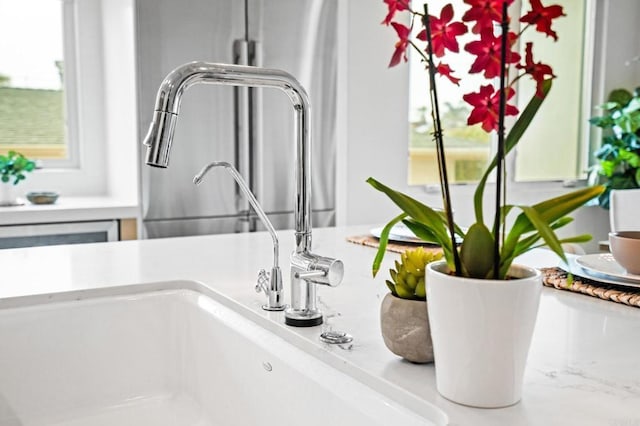 kitchen view of a sink and light countertops