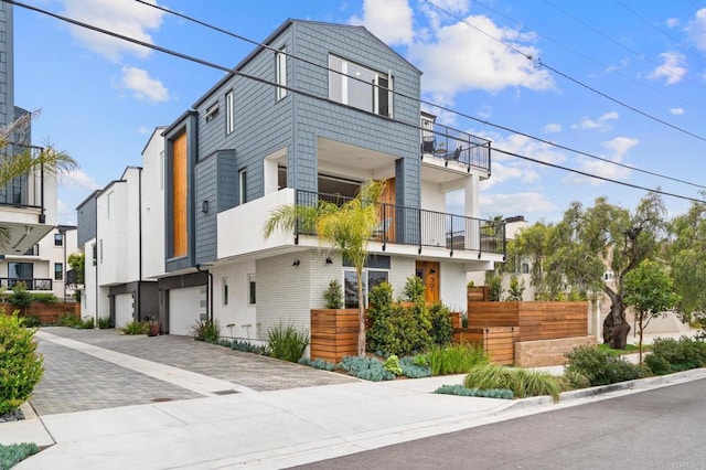 view of front of house with a garage and decorative driveway