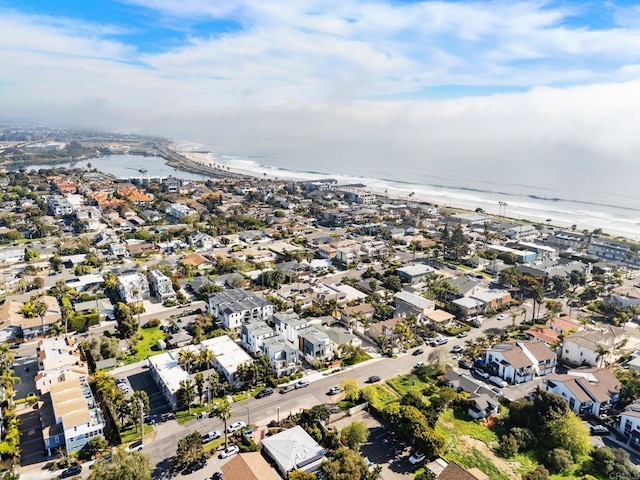 view of property location with waterfront with a beach and nearby suburban area