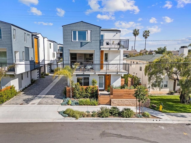 view of front of home with a residential view and driveway