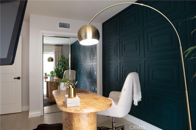 dining area featuring baseboards, wood finished floors, and visible vents