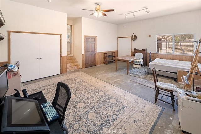 interior space with unfinished concrete flooring and a ceiling fan