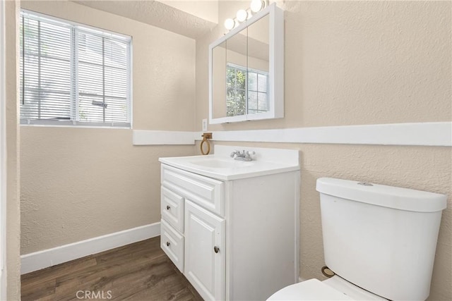 1335 N Lugo Ave, San Bernardino, CA 92404 - half bathroom featuring wood finished floors, toilet, a textured wall, and vanity