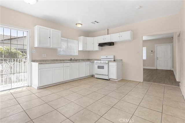 1335 N Lugo Ave, San Bernardino, CA 92404 - kitchen featuring gas range gas stove, a healthy amount of sunlight, light countertops, and under cabinet range hood