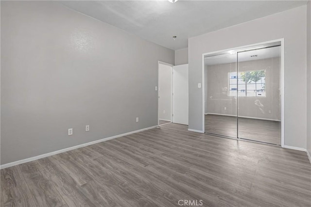 1335 N Lugo Ave, San Bernardino, CA 92404 - unfurnished bedroom featuring wood finished floors, a closet, and baseboards