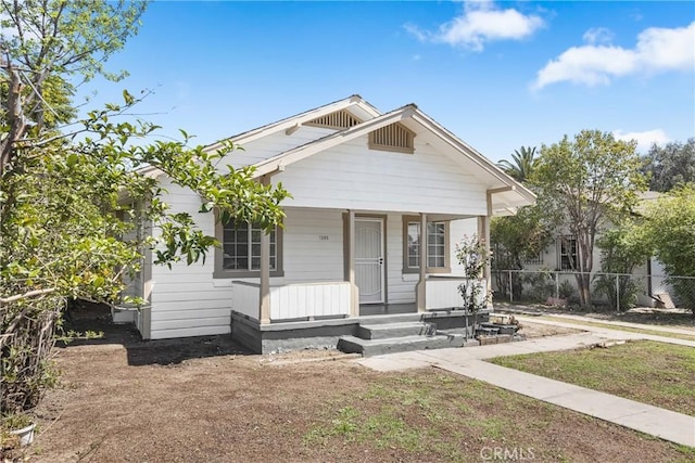 1335 N Lugo Ave, San Bernardino, CA 92404 - bungalow-style house with fence and covered porch