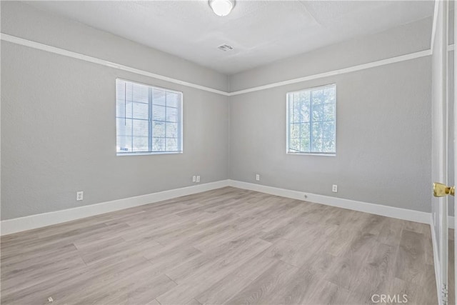 1335 N Lugo Ave, San Bernardino, CA 92404 - unfurnished room with baseboards, light wood-style flooring, and plenty of natural light