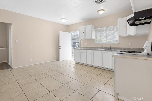 1335 N Lugo Ave, San Bernardino, CA 92404 - kitchen featuring under cabinet range hood, range, visible vents, white cabinetry, and light countertops