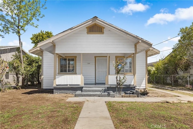 1335 N Lugo Ave, San Bernardino, CA 92404 - bungalow featuring a front yard, covered porch, and fence