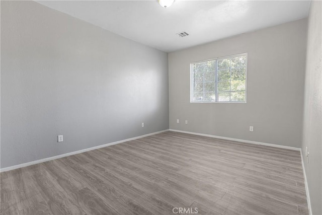 1335 N Lugo Ave, San Bernardino, CA 92404 - empty room featuring baseboards, visible vents, and wood finished floors