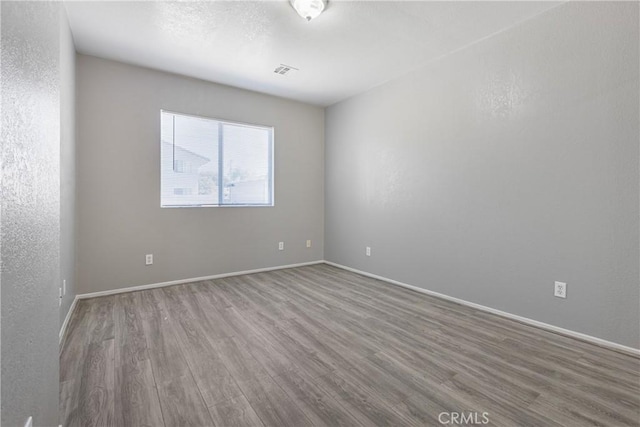 1335 N Lugo Ave, San Bernardino, CA 92404 - empty room featuring baseboards, visible vents, and wood finished floors