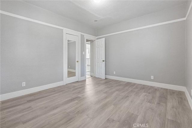 1335 N Lugo Ave, San Bernardino, CA 92404 - spare room featuring wood finished floors and baseboards