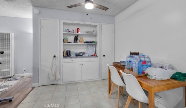 2501 W Redondo Beach Blvd Unit 217, Gardena, CA 90249 - dining room with a heating unit, a ceiling fan, a textured ceiling, and light tile patterned floors