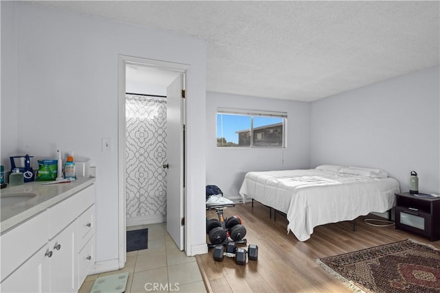 2501 W Redondo Beach Blvd Unit 217, Gardena, CA 90249 - bedroom with light wood-style flooring, a sink, and a textured ceiling
