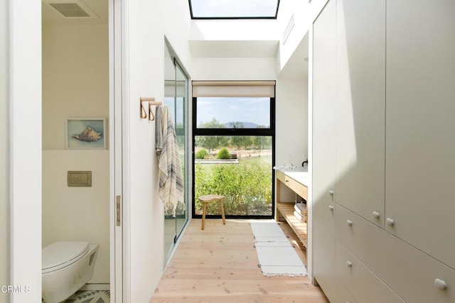 11100 Sulphur Mountain Rd, Ojai, CA 93023 - bathroom featuring visible vents, wood finished floors, toilet, and a skylight