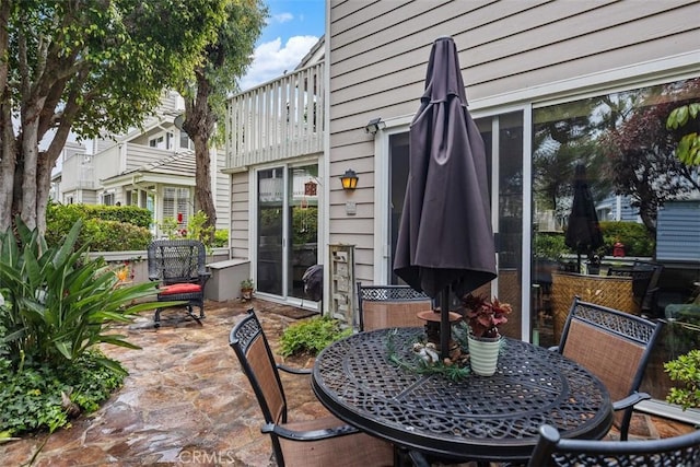 view of patio / terrace with a balcony and outdoor dining space