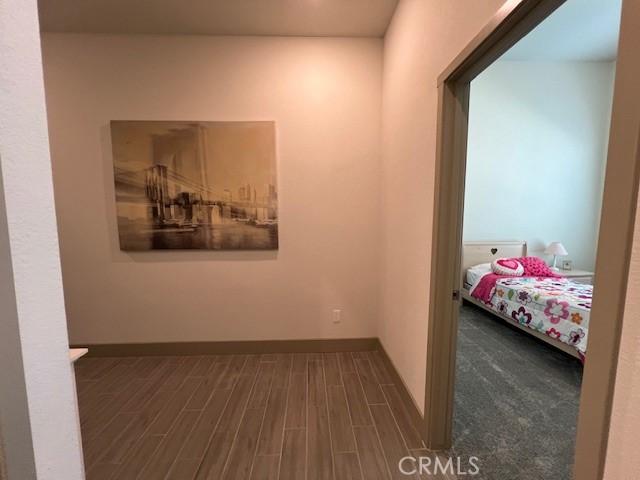 hallway featuring dark wood-style flooring
