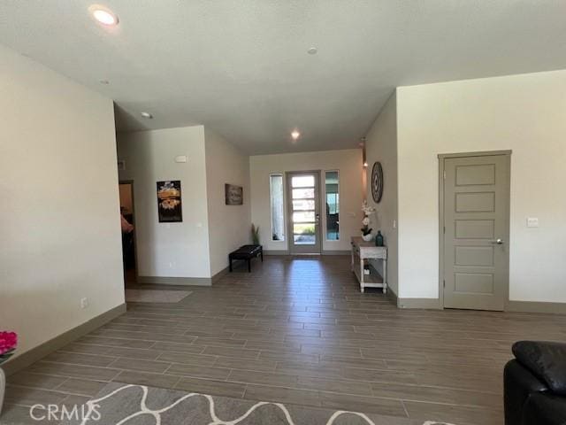 living room featuring baseboards, recessed lighting, and wood finish floors