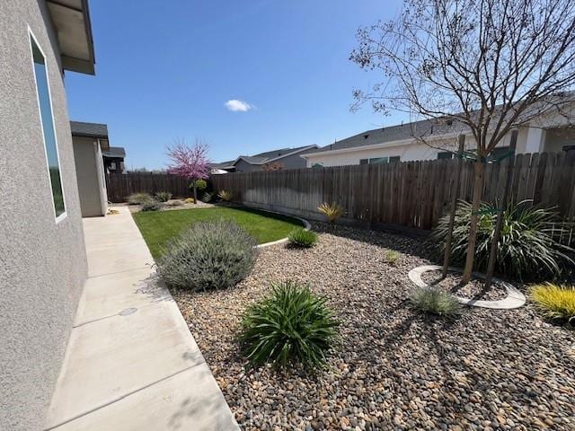 view of yard with a fenced backyard