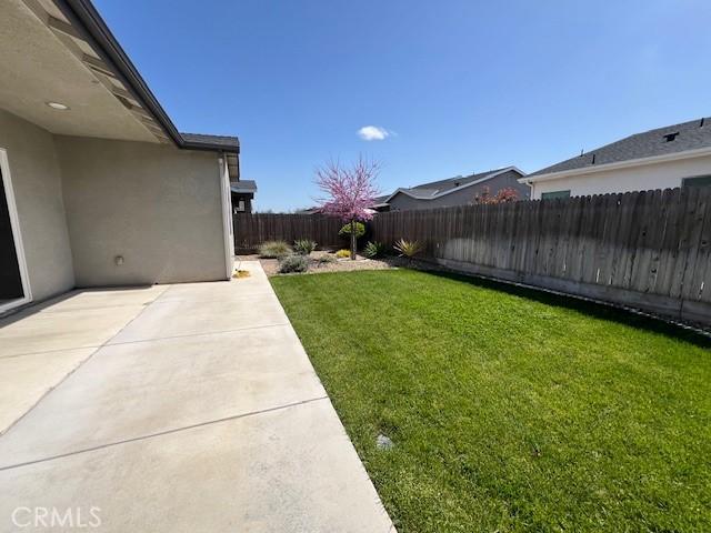 view of yard with a fenced backyard and a patio