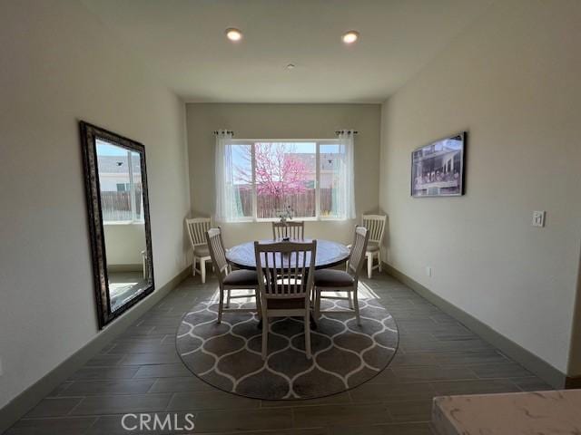 dining room featuring recessed lighting, baseboards, and wood finished floors