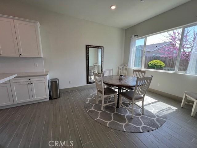 dining area featuring recessed lighting, dark wood-type flooring, and baseboards