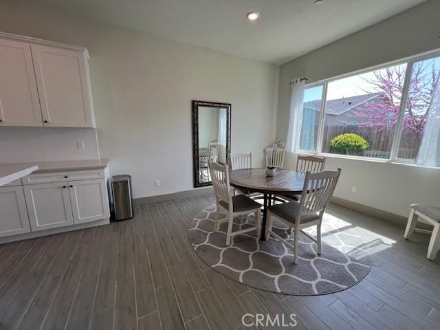 dining space featuring baseboards, dark wood-style floors, and recessed lighting