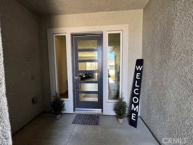 view of exterior entry with stucco siding