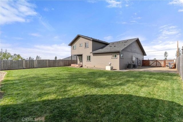 rear view of house with a yard, a fenced backyard, and central AC