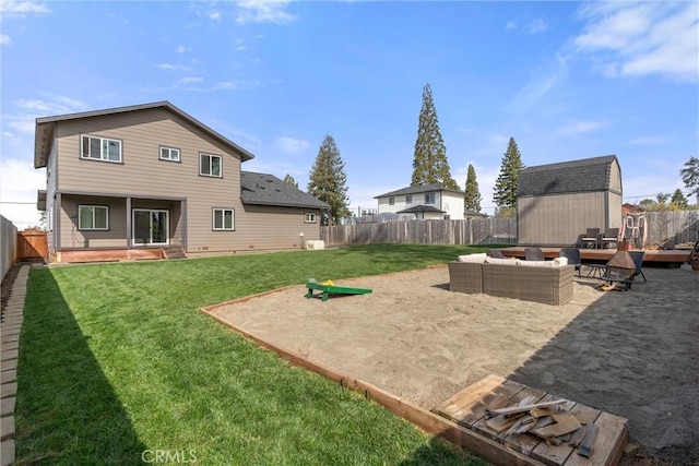 rear view of house with a shed, a yard, a fenced backyard, an outdoor living space, and an outbuilding