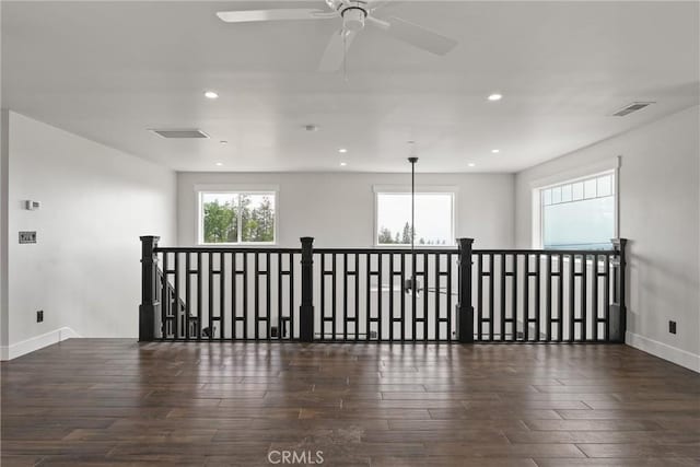 empty room with visible vents, recessed lighting, wood-type flooring, and a ceiling fan