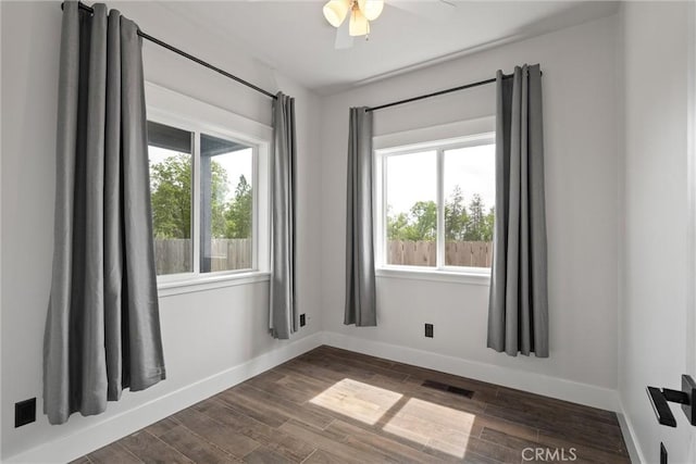 spare room with a healthy amount of sunlight, baseboards, and visible vents