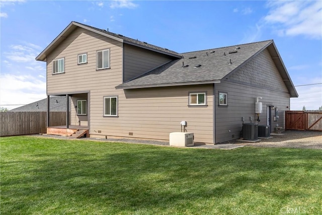 rear view of property with roof with shingles, central air condition unit, a fenced backyard, and a lawn
