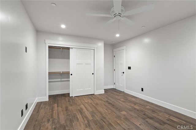 unfurnished bedroom with a closet, recessed lighting, baseboards, and wood finished floors