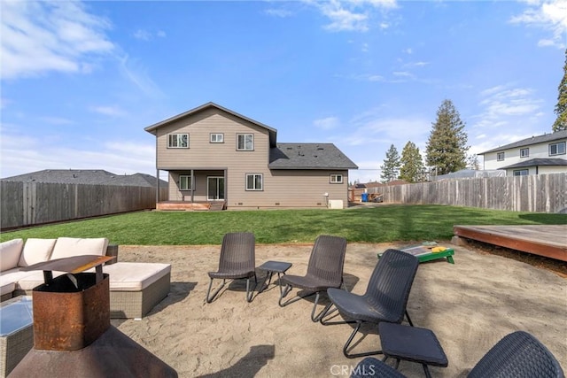 back of house with a fenced backyard, a patio area, and a lawn