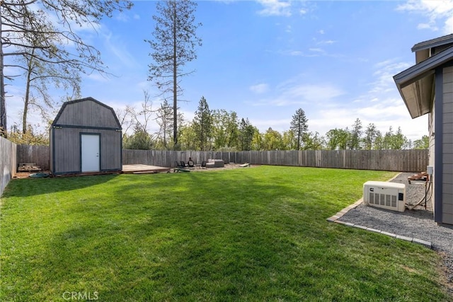 view of yard with a fenced backyard, a storage shed, and an outdoor structure