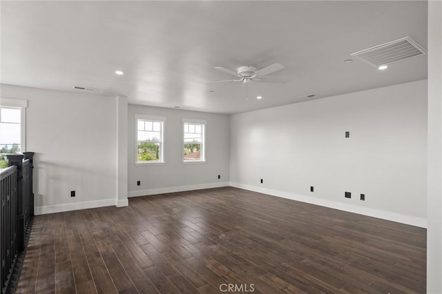 spare room with recessed lighting, visible vents, baseboards, and dark wood finished floors