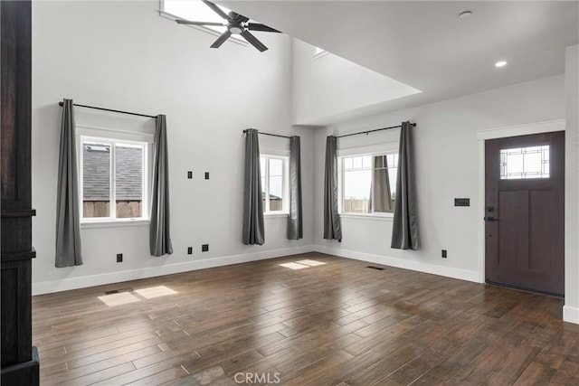 foyer entrance with dark wood finished floors, baseboards, and ceiling fan