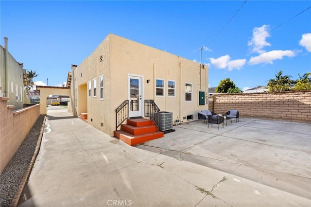 back of property featuring central air condition unit, stucco siding, a patio, entry steps, and fence