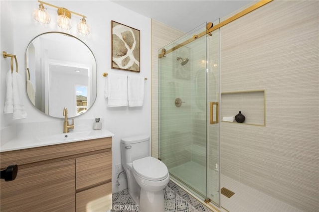 bathroom featuring tile patterned floors, toilet, a stall shower, and vanity