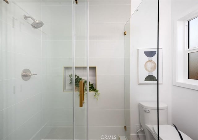 full bathroom featuring toilet and a shower stall
