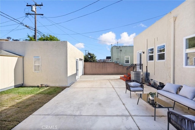 view of patio with outdoor lounge area, central AC, fence, and an outbuilding