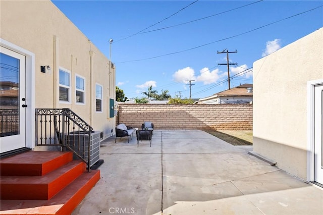 view of patio with fence and central air condition unit