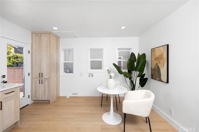 sitting room featuring baseboards, light wood finished floors, attic access, and recessed lighting