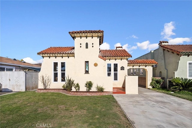 mediterranean / spanish house with a tiled roof and stucco siding