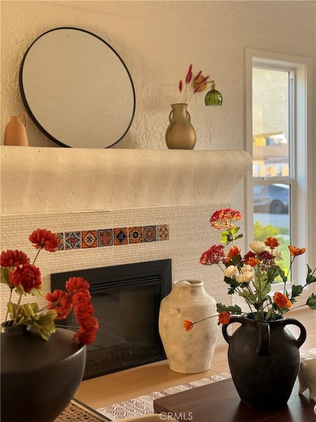 details with a textured wall and a fireplace