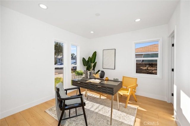 office space featuring baseboards, light wood finished floors, and recessed lighting
