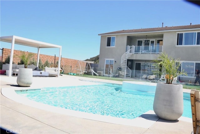 view of pool featuring stairway, fence, a patio area, and a fenced in pool