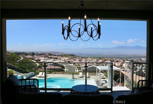 view of swimming pool with a residential view, a fenced in pool, and a mountain view